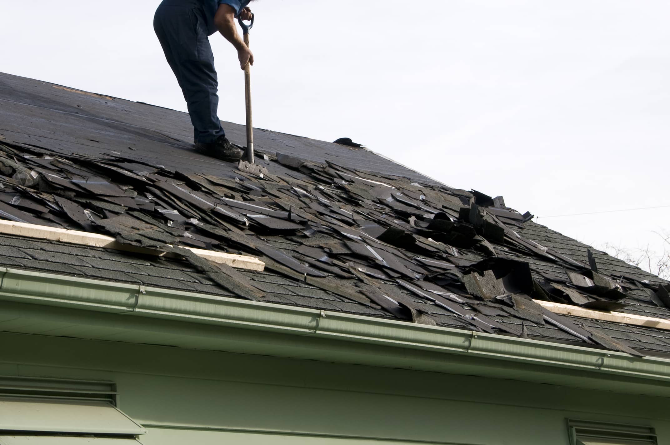 This is an image of a contractor preparing to replace a damaged roof.