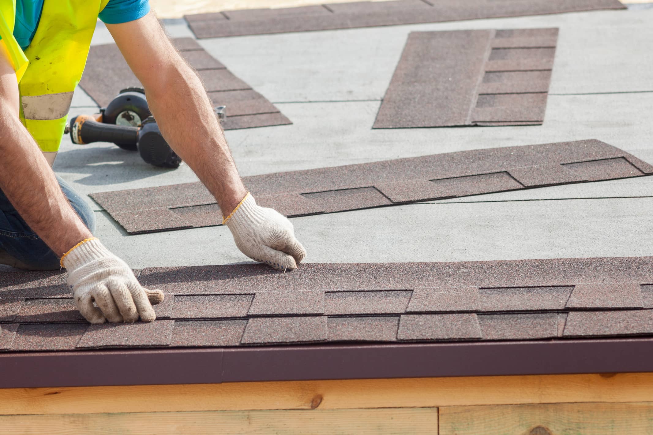 This is an image of a roofing contractor replacing roof shingles.